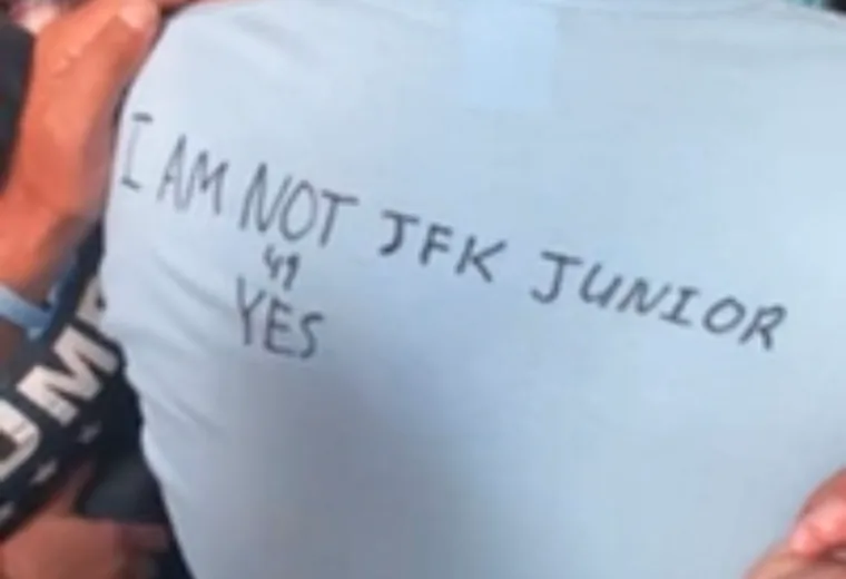 Handwritten message on a shirt in an outdoor crowd