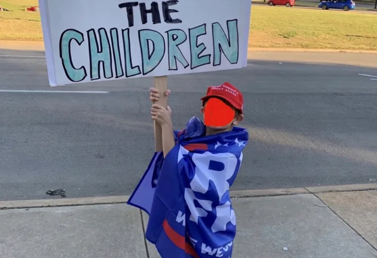 Roadside participant holding a Save the Children sign