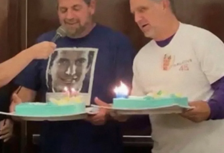 Captioned birthday image of two men carrying cakes